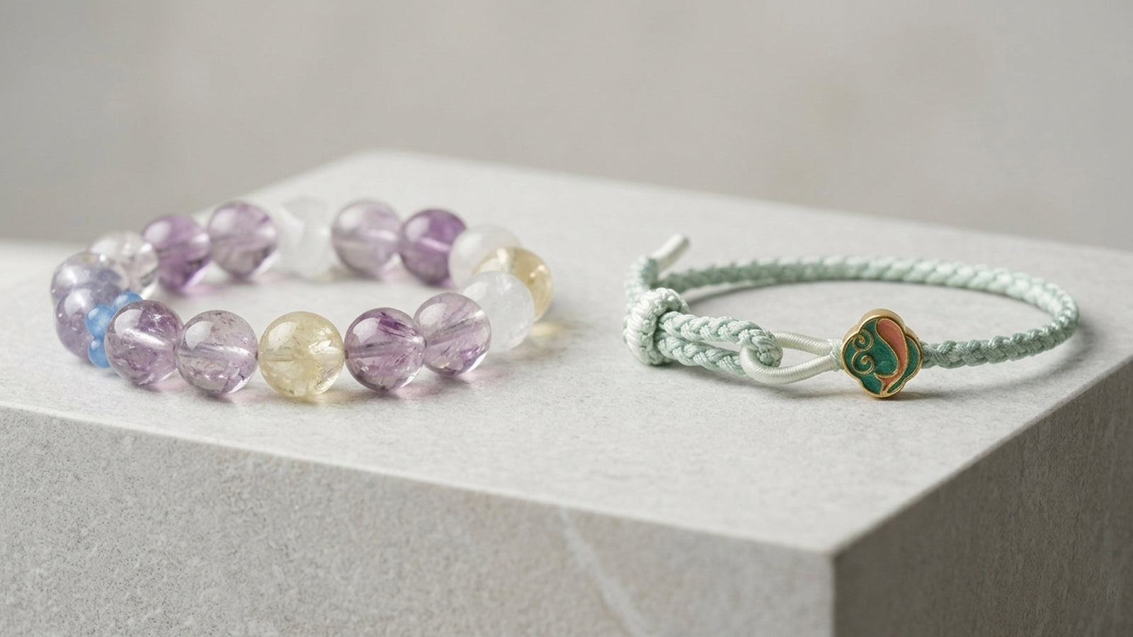 Purple gemstone bracelet and pale green hand-knotted bracelet displayed side by side